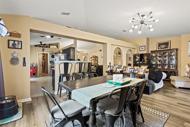 dining area with hardwood / wood-style flooring and a chandelier