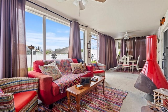 sunroom / solarium featuring plenty of natural light and ceiling fan