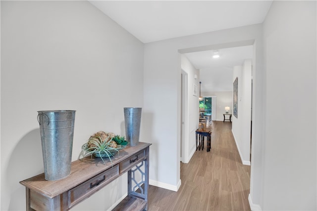 hallway with hardwood / wood-style flooring