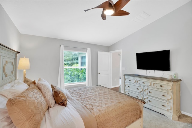 carpeted bedroom with vaulted ceiling and ceiling fan