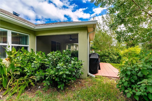 view of home's exterior featuring ceiling fan and a patio area