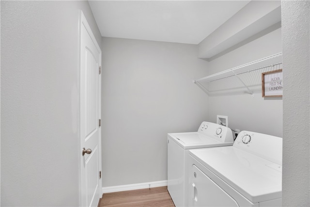 laundry area featuring light hardwood / wood-style flooring and independent washer and dryer