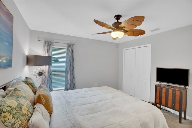 carpeted bedroom with ceiling fan and a closet