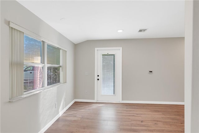 interior space featuring vaulted ceiling and light wood-type flooring