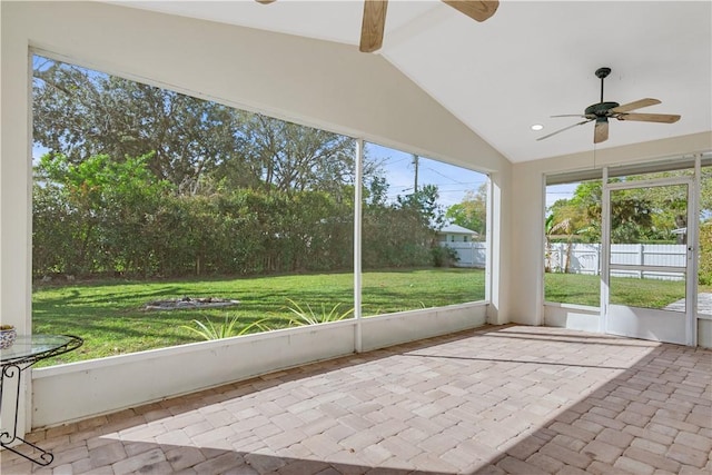 unfurnished sunroom with vaulted ceiling and ceiling fan