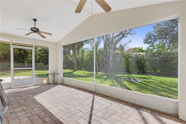 unfurnished sunroom with vaulted ceiling with beams and ceiling fan