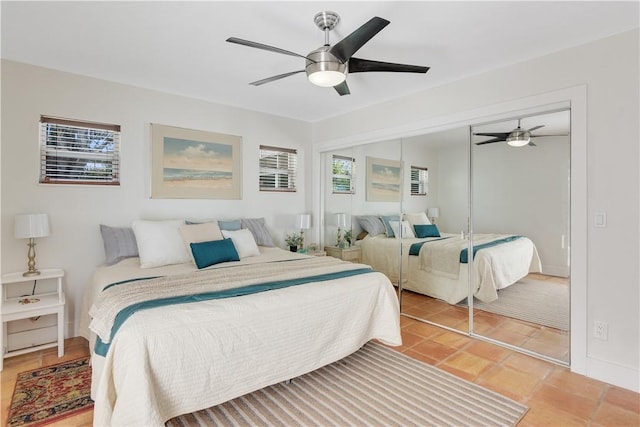 bedroom with ceiling fan, a closet, and multiple windows