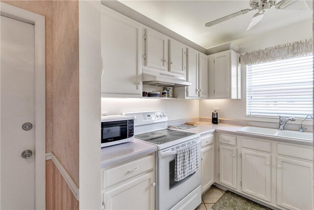 kitchen with ceiling fan, sink, light tile patterned floors, white appliances, and white cabinets