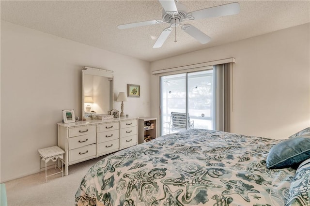 bedroom with ceiling fan, light colored carpet, a textured ceiling, and access to outside