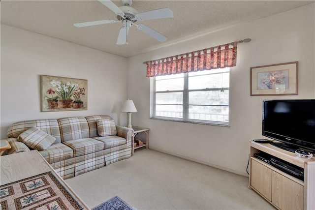 carpeted living room with ceiling fan