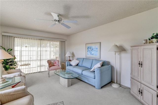 carpeted living room with a textured ceiling and ceiling fan