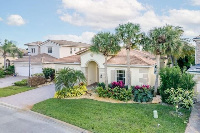 mediterranean / spanish house with a front yard