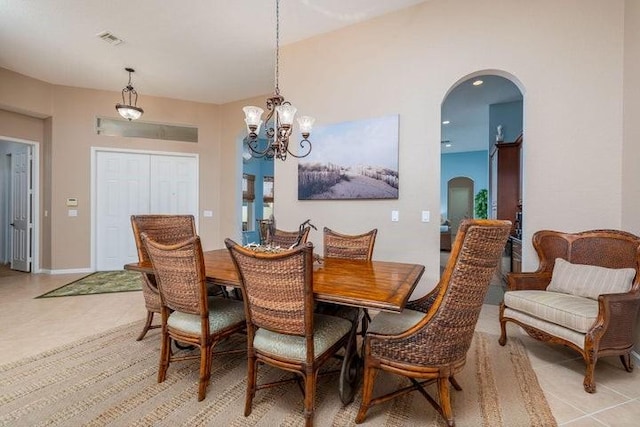 tiled dining area with a chandelier