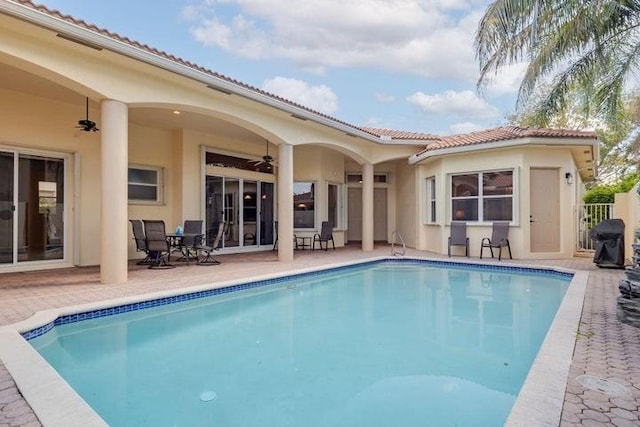 view of pool featuring ceiling fan and a patio