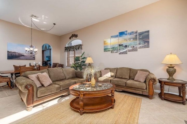 living room featuring light tile patterned floors and an inviting chandelier