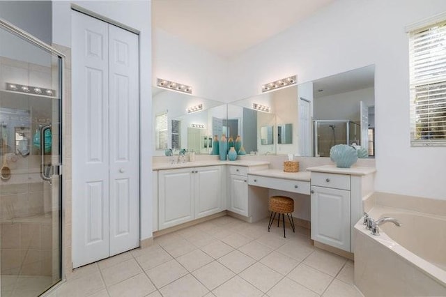 bathroom with tile patterned floors, vanity, and separate shower and tub