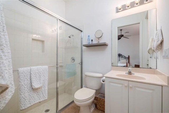 bathroom featuring tile patterned floors, ceiling fan, toilet, and walk in shower