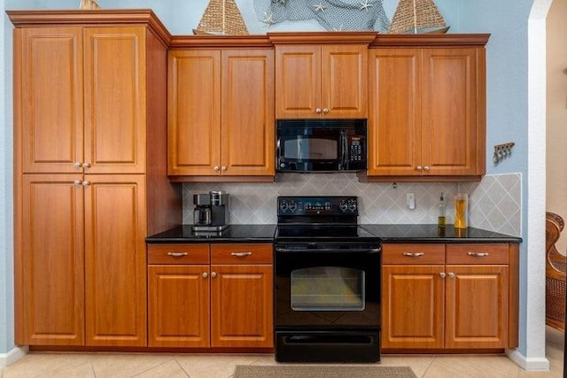 kitchen with black appliances, light tile patterned flooring, and backsplash