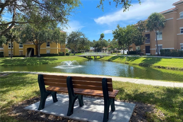 view of community featuring a water view and a lawn