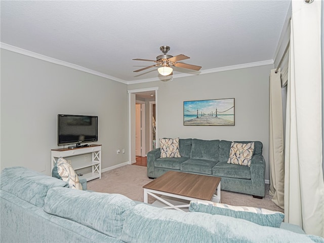 living room with a textured ceiling, light colored carpet, ceiling fan, and crown molding