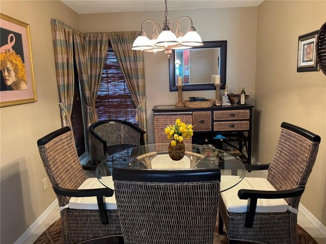 625 W Lake Jasmine Cir Unit 208, Vero Beach, FL 32962 - dining area with a chandelier and baseboards