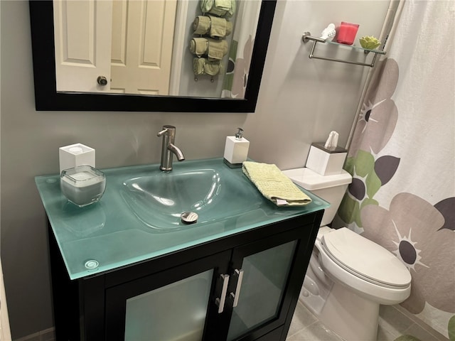 bathroom featuring toilet, vanity, and tile patterned floors