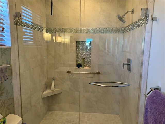 bathroom with a shower with shower door