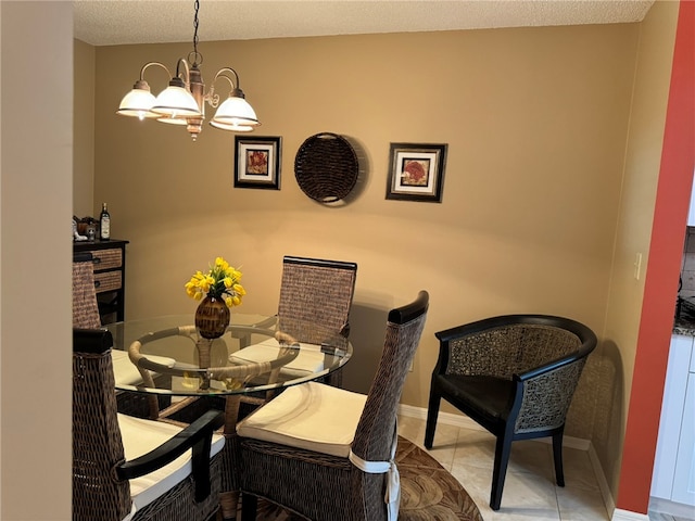 tiled dining room with a chandelier and a textured ceiling