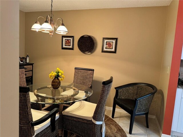 625 W Lake Jasmine Cir Unit 208, Vero Beach, FL 32962 - tiled dining space with a chandelier and baseboards