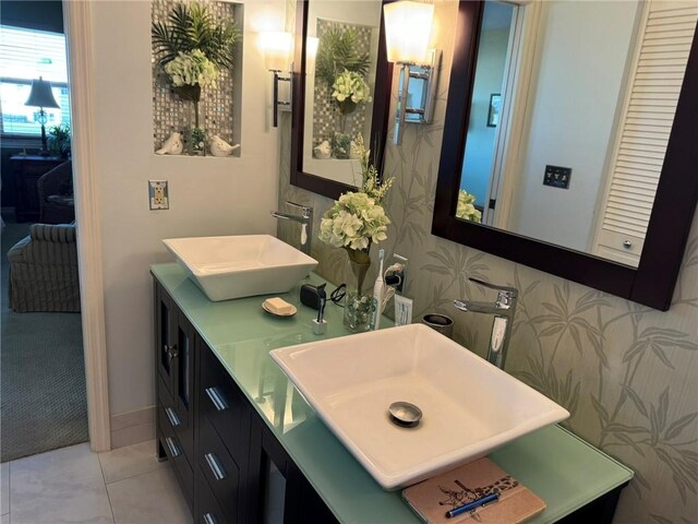 625 W Lake Jasmine Cir Unit 208, Vero Beach, FL 32962 - bathroom with double vanity, wallpapered walls, and tile patterned floors