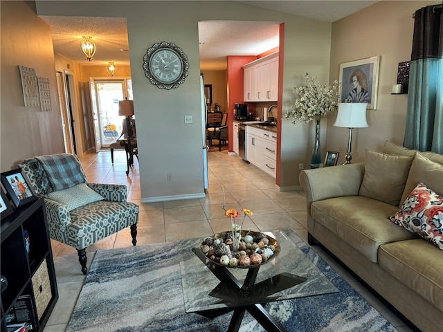 living room featuring light tile patterned flooring, sink, and a textured ceiling