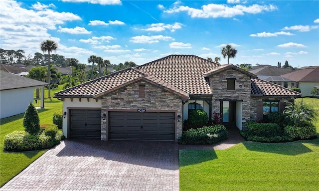 view of front of property featuring a garage and a front lawn