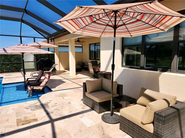 6210 Arcadia Sq, Vero Beach, FL 32966 - view of patio / terrace featuring an outdoor pool, ceiling fan, glass enclosure, and outdoor lounge area