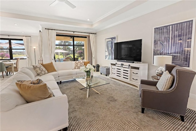 living room with plenty of natural light, ornamental molding, and ceiling fan