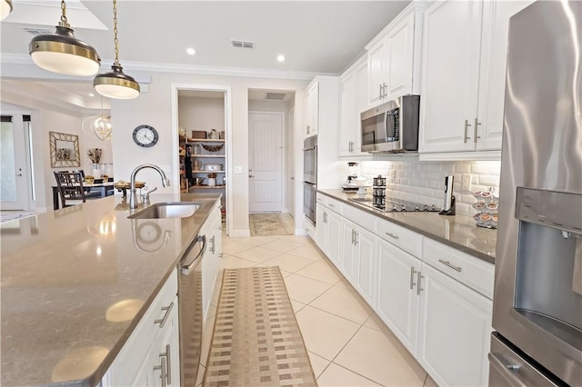 6210 Arcadia Sq, Vero Beach, FL 32966 - kitchen featuring stainless steel appliances, a sink, light tile patterned floors, tasteful backsplash, and crown molding