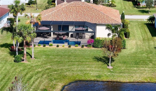 birds eye view of property with a water view