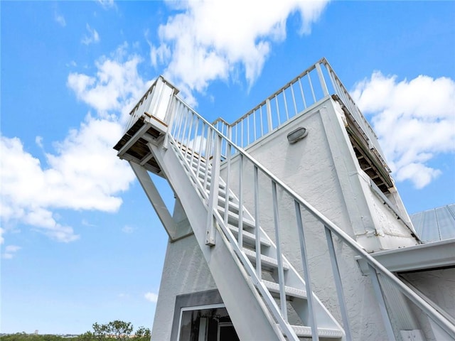 view of side of home with stairs
