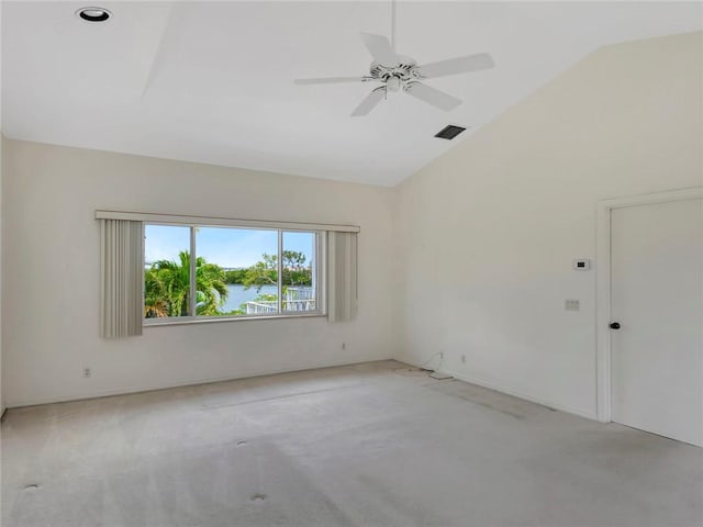 spare room with lofted ceiling, light carpet, a ceiling fan, and visible vents