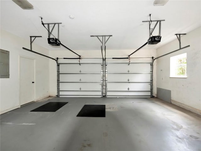 garage featuring electric panel and a garage door opener