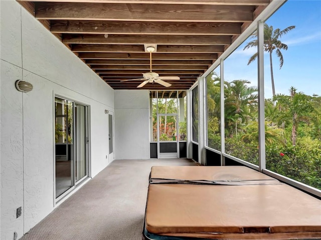 unfurnished sunroom with ceiling fan