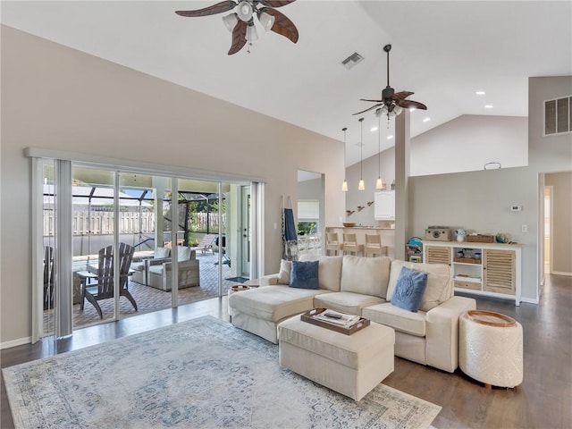 living room with high vaulted ceiling, ceiling fan, and dark wood-type flooring