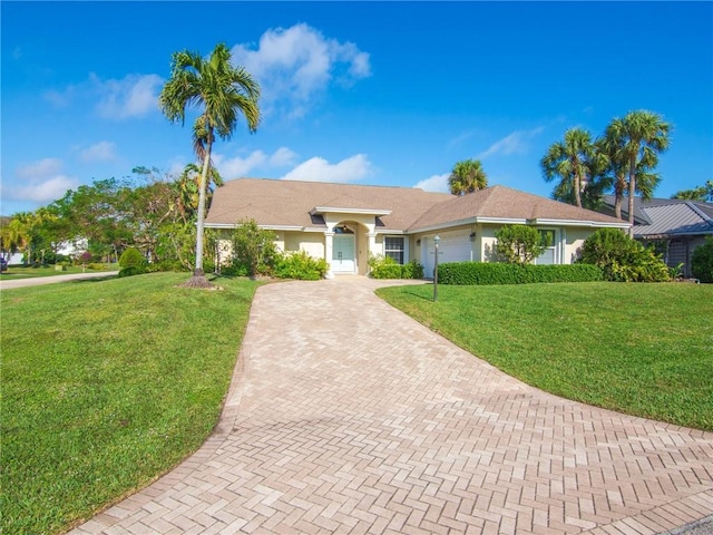 ranch-style home with a front yard and a garage