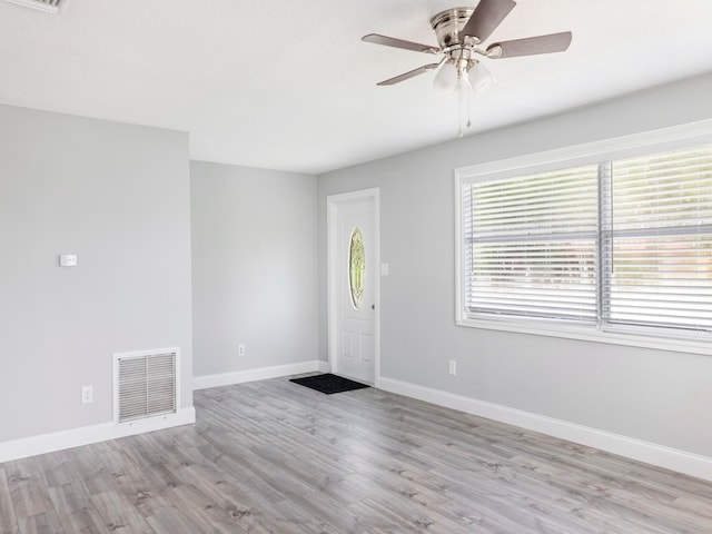 foyer with light wood-type flooring and ceiling fan