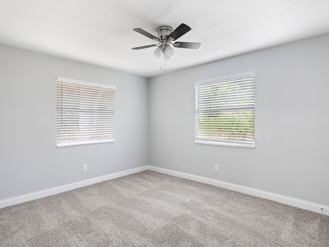 spare room featuring ceiling fan and carpet floors