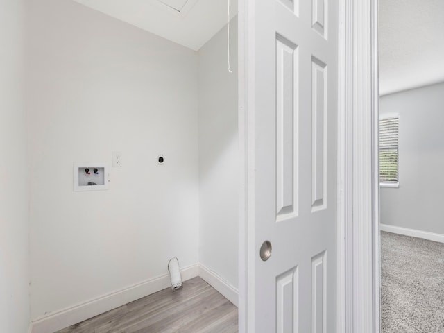 clothes washing area featuring light hardwood / wood-style floors, washer hookup, and electric dryer hookup