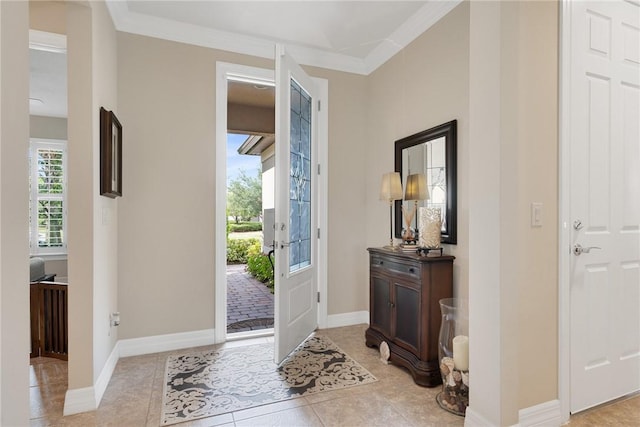 tiled foyer featuring ornamental molding