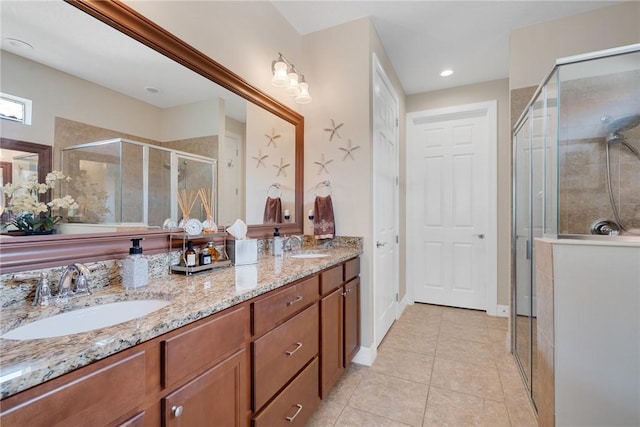 bathroom with tile patterned flooring, vanity, and a shower with door