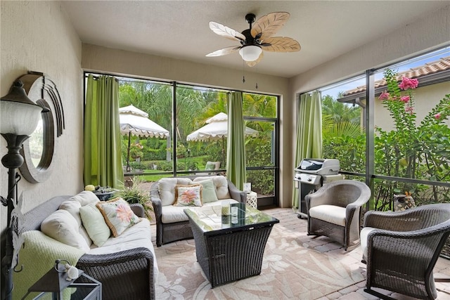 sunroom featuring ceiling fan and plenty of natural light