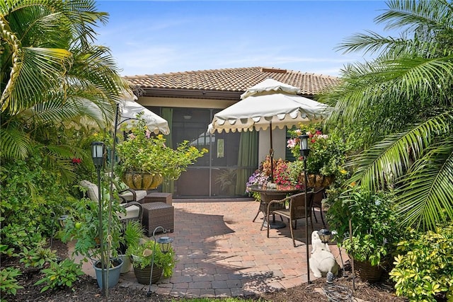 view of patio / terrace featuring a sunroom