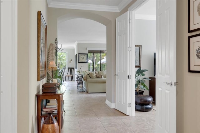 hallway with light tile patterned flooring and crown molding